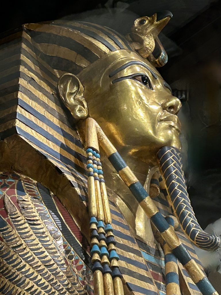 Close view of Tutankhamun’s golden funerary mask showing the ceremonial beard and headdress