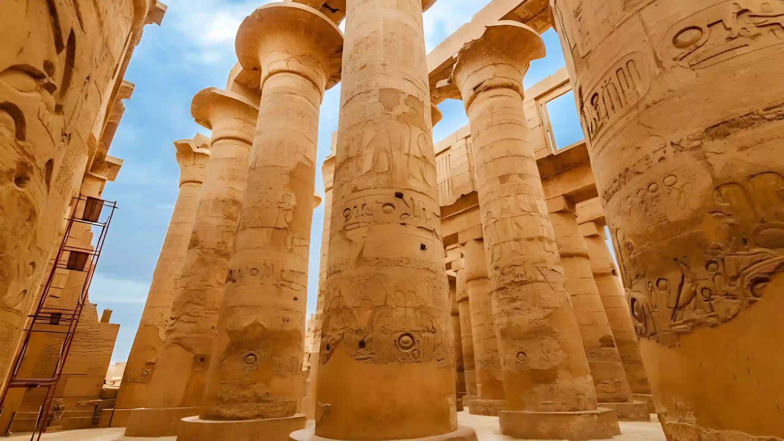 Massive stone columns covered with hieroglyphs inside an ancient Egyptian temple