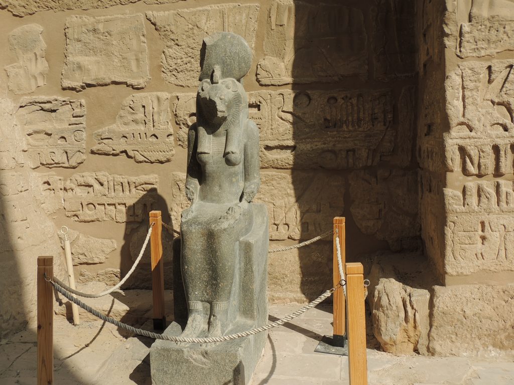 Ancient Egyptian statue of lion-headed goddess Sekhmet seated inside the Temple of Mut complex at Karnak, Luxor