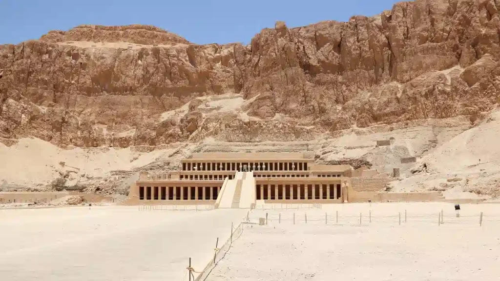 Central staircase leading to the statues of Queen Hatshepsut temple at Deir el Bahari in Luxor Egypt with desert cliffs behind