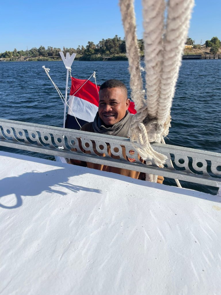 Captain Ramdan on the felucca Maitea sailing on the Nile near Aswan Egypt
